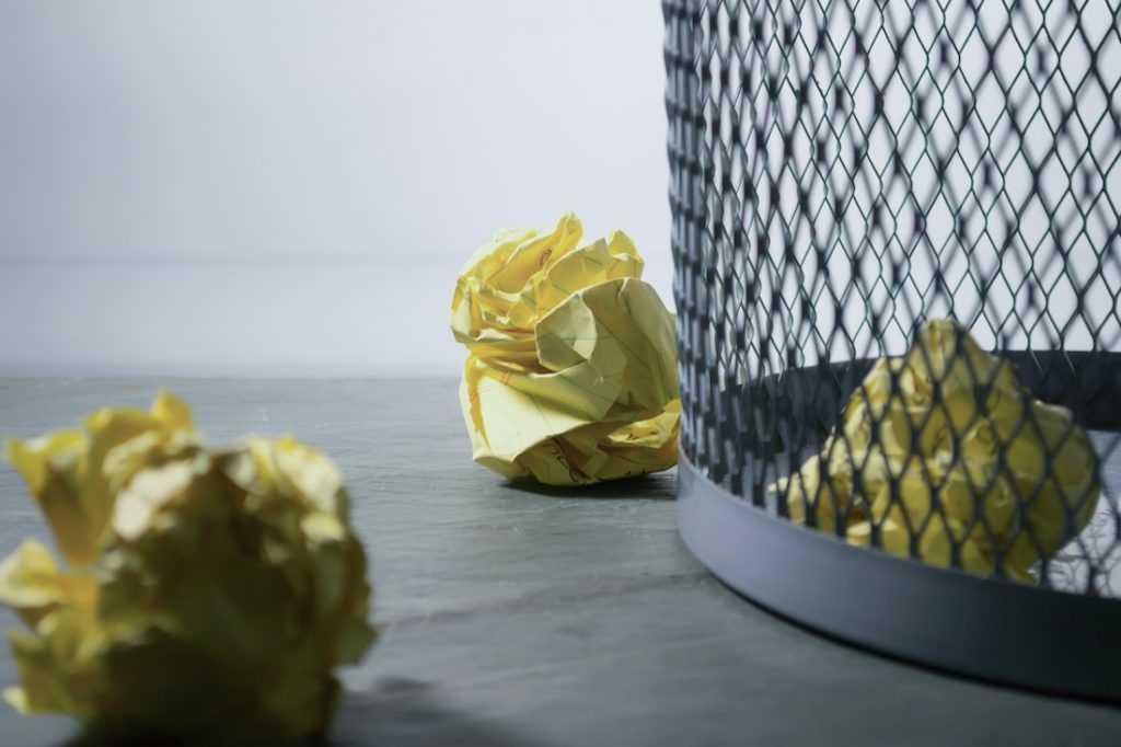 crumpled paper in wastebasket