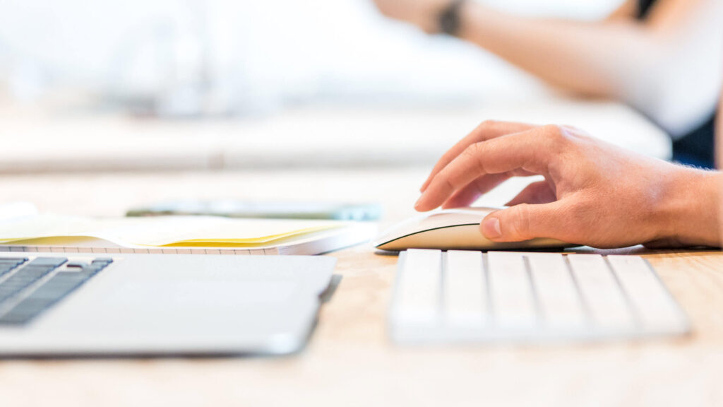 A person moving a mouse around next to a keyboard, The Do’s and Don'ts of Writing Professional Script Coverage