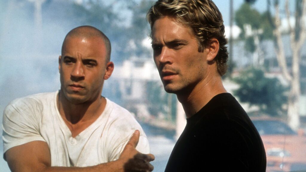 Dominic (Vin Diesel) and Brian (Paul Walker) standing on the street during 'The Fast and the Furious,' A Writer's Guide to Balancing Artistic Vision and Commercial Appeal