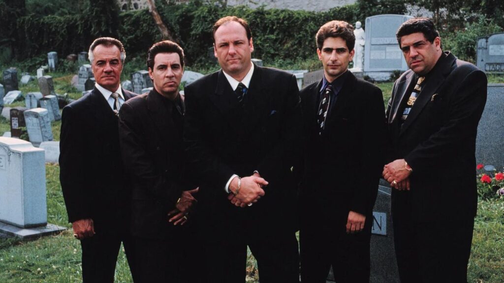 The male cast of 'The Sopranos' standing in front of tombstones