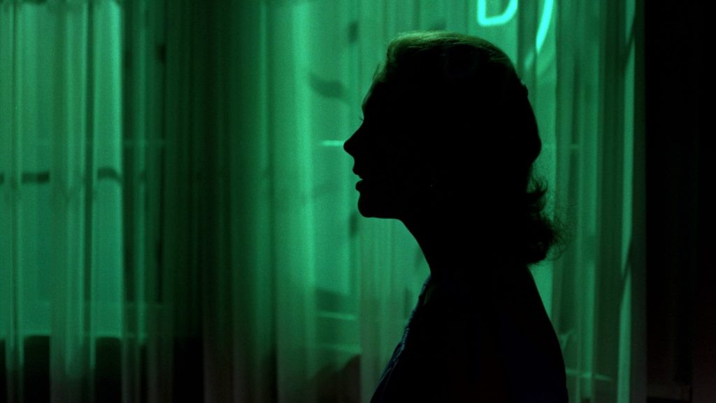 Judy (Kim Novak) hidden in shadows in a hotel room in 'Vertigo,' 100 Internal Conflicts Your Characters Can Face