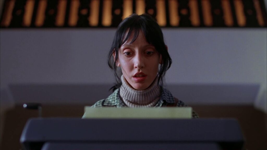 Wendy Torrance (Shelley Duvall) reading paper in a typewriter in 'The Shining'