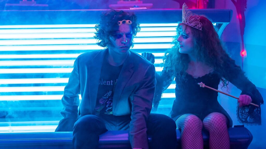 Lisa (Kathryn Newton) and her monster (Cole Sprouse) sitting on a tanning bed in 'Lisa Frankenstein'