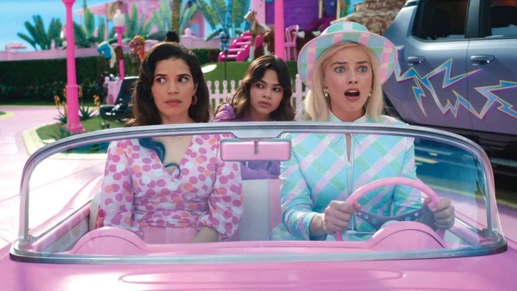 Gloria (America Ferrera), Sasha (Ariana Greenblatt), and Barbie (Margot Robbie) shocked in a car in 'Barbie'