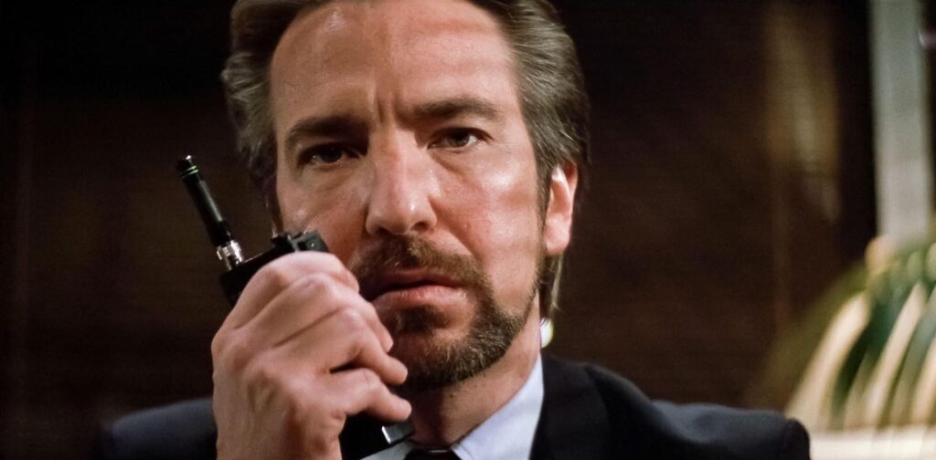 Hans Gruber, played by Alan Rickman, talking into a walkie talkie in 'Die Hard,' 200 Heroic and Villainous Character Traits