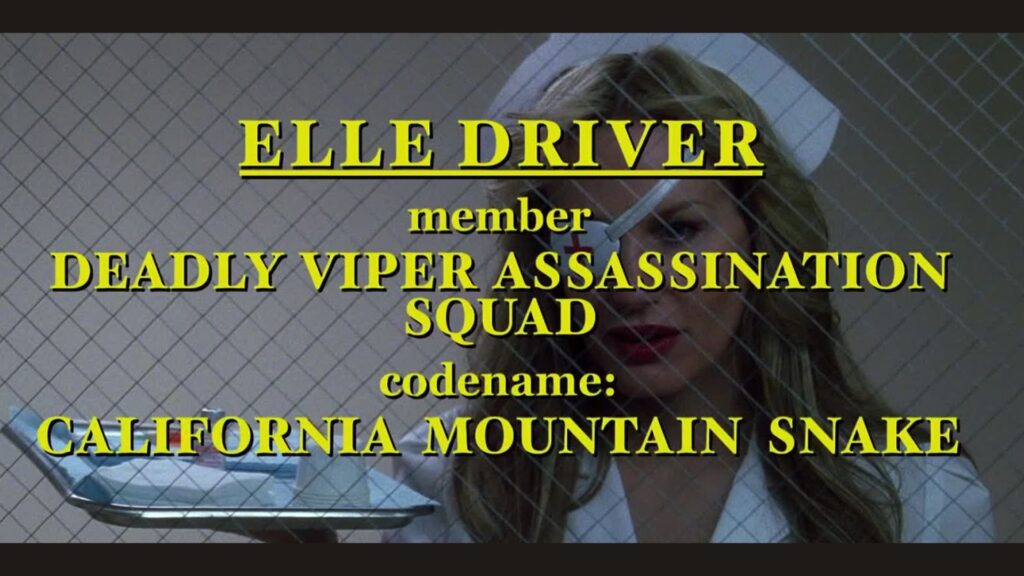 Title card with yellow writing introducing Elle Driver (Daryl Hannah) in ‘Kill Bill: Vol. 1,’ '5 Trademarks of Quentin Tarantino Movies'