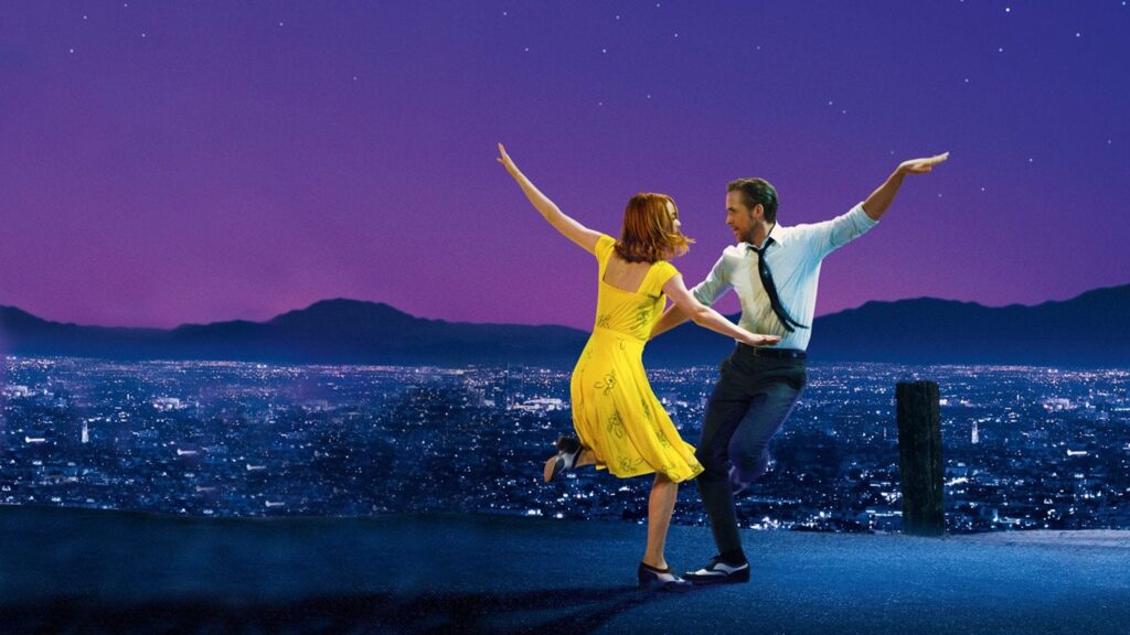 Mia (Emma Stone) in a yellow dress dancing with Seb (Ryan Gosling) over the Los Angeles skyline in 'La La Land,' 100 Meet-Cute Scenarios to Spark Your Screenplay's Romance