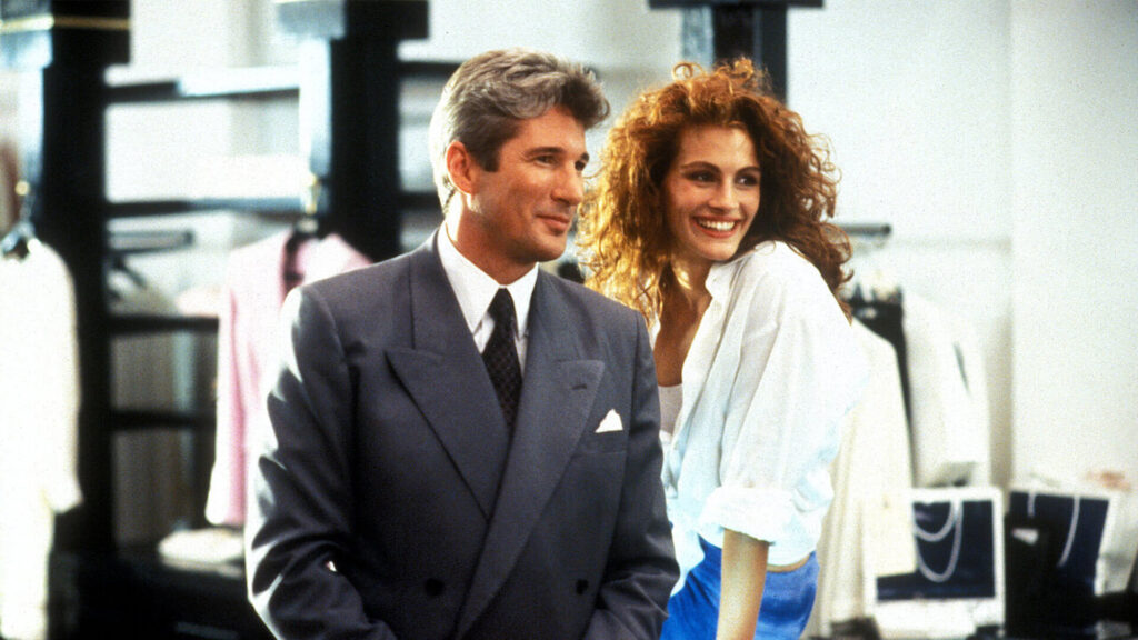 Edward Lewis (Richard Gere) and Vivian Ward (Julia Roberts) sitting next to each other in an office in 'Pretty Woman,' What Is a Meet-Cute? 3 Unforgettable Ways to Start Your Romance