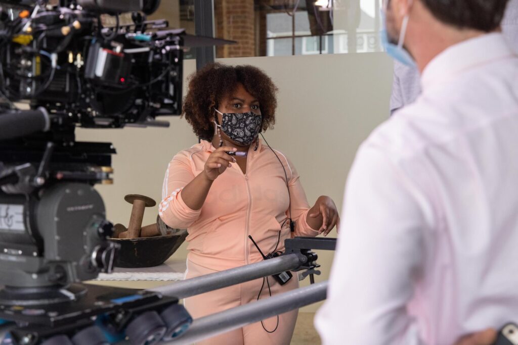 Destiny Macon is a peach sweatsuit behind the camera on the set of 'Talk Black'