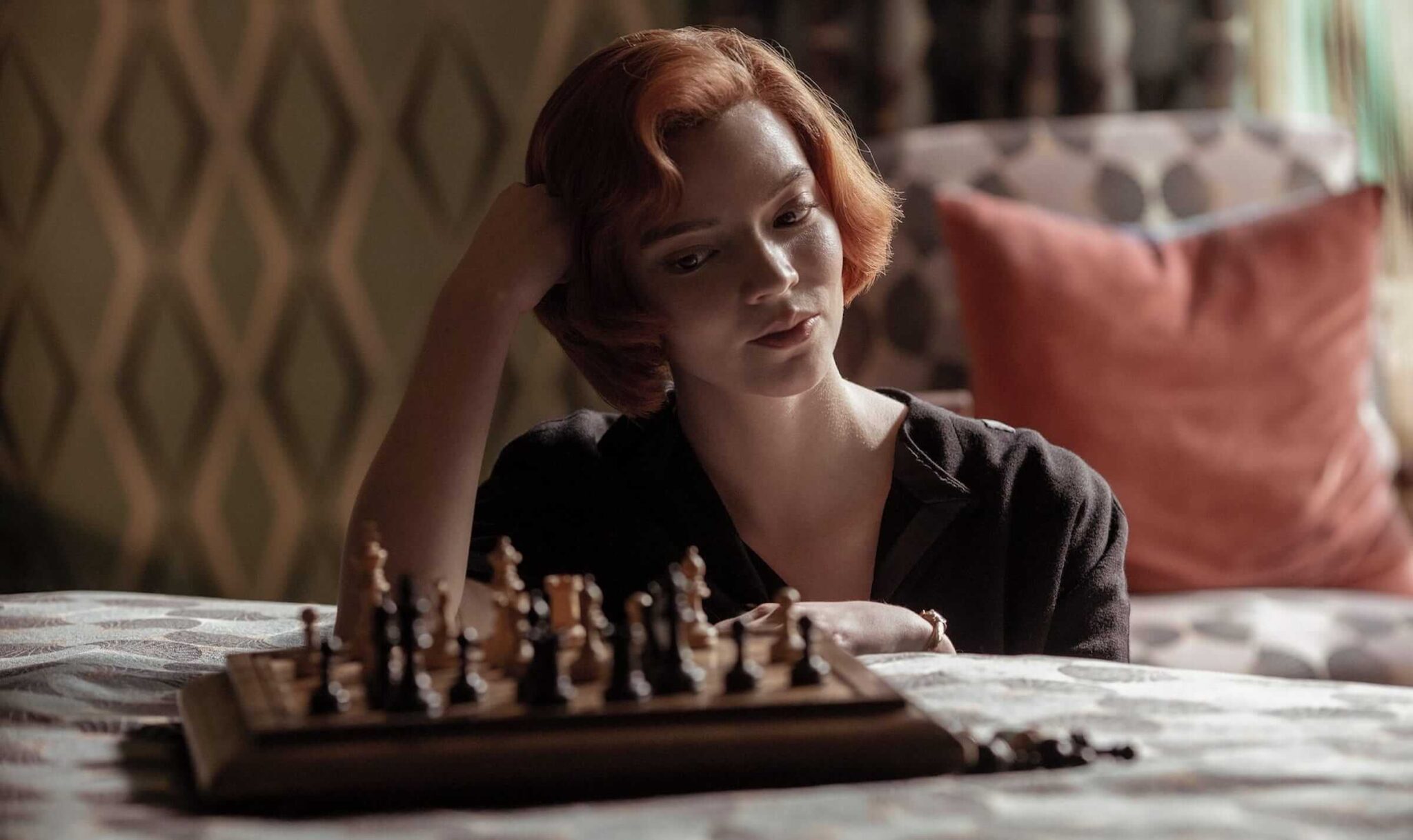 Beth (Anya Taylor-Joy) playing chess against on a bed in 'The Queen's Gambit,' 100 Symbolism Prompts for Stories