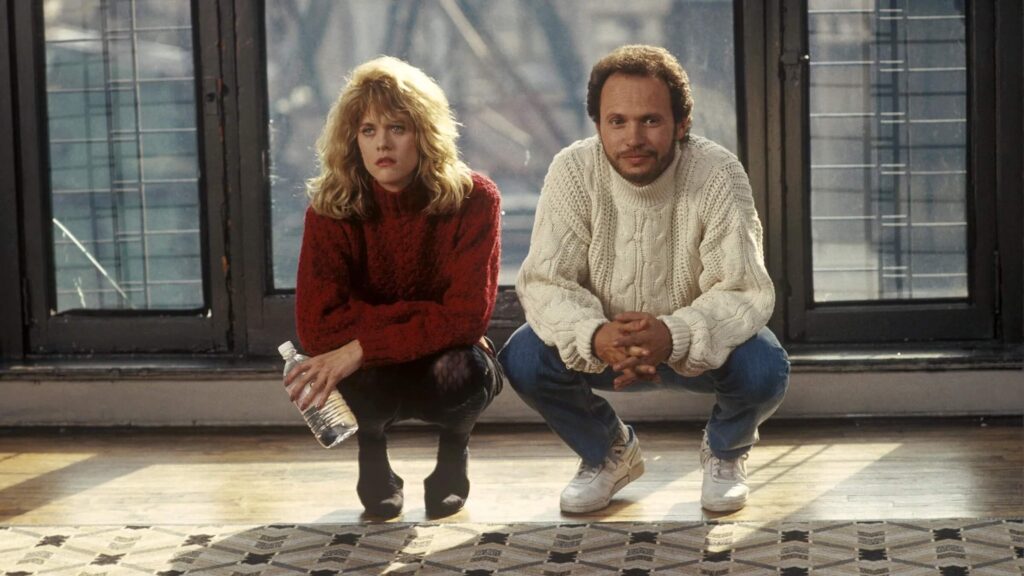 Harry Burns (Billy Crystal) and Sally Albright (Meg Ryan) squatting while looking at a rug in 'When Harry Met Sally,' What Is a Meet-Cute? 3 Unforgettable Ways to Start Your Romance