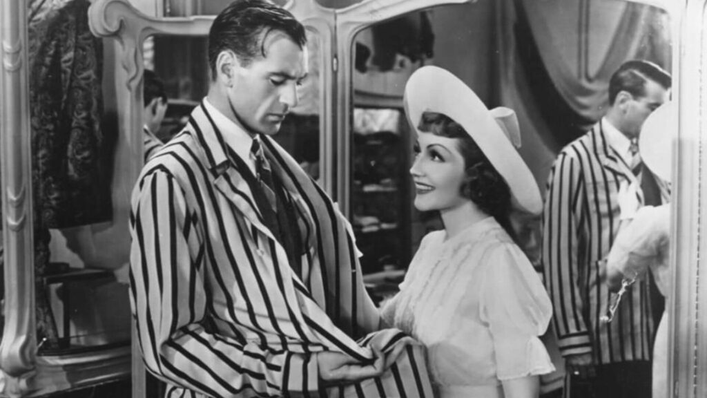 Nicole de Loiselle (Claudette Colbert) and Michael Brandon (Gary Cooper) smiling at each other while shopping in 'Bluebeard's Eighth Wife'