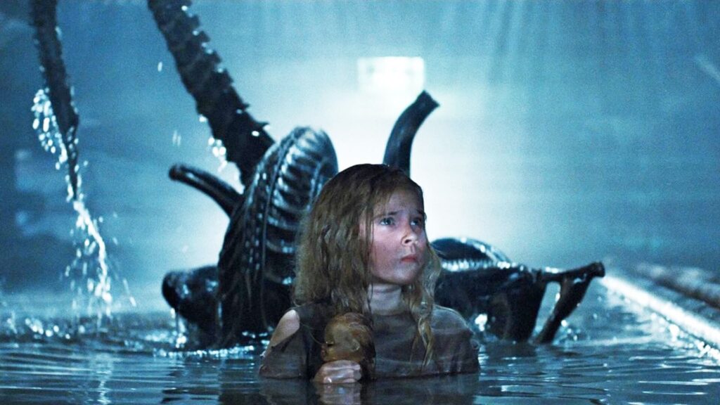 An alien emerging from the water behind Newt (Carrie Henn) in 'Aliens'