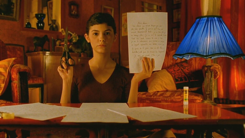 Amélie Poulain (Audrey Tautou) holding a note and scissors in ‘Amelie’