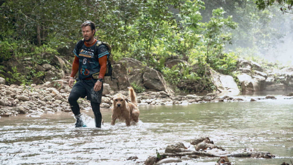 Michael Light (Mark Wahlberg) and Arthur (Ukai) walking through a river in 'Arthur the King'