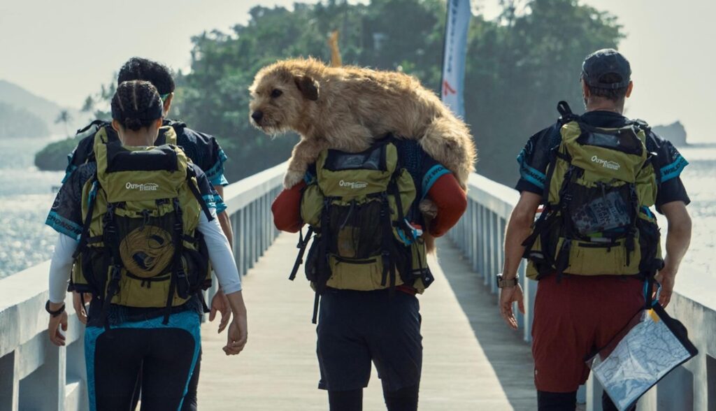 Michael Light (Mark Wahlberg) carrying Arthur on his back as he and his team walk down a bridge in 'Arthur the King'