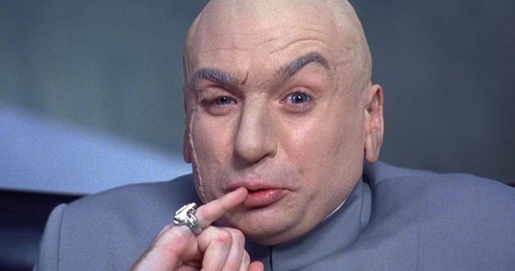 Dr. Evil (Mike Meyers) holding his pinky to his lips in 'Austin Powers: International Man of Mystery'