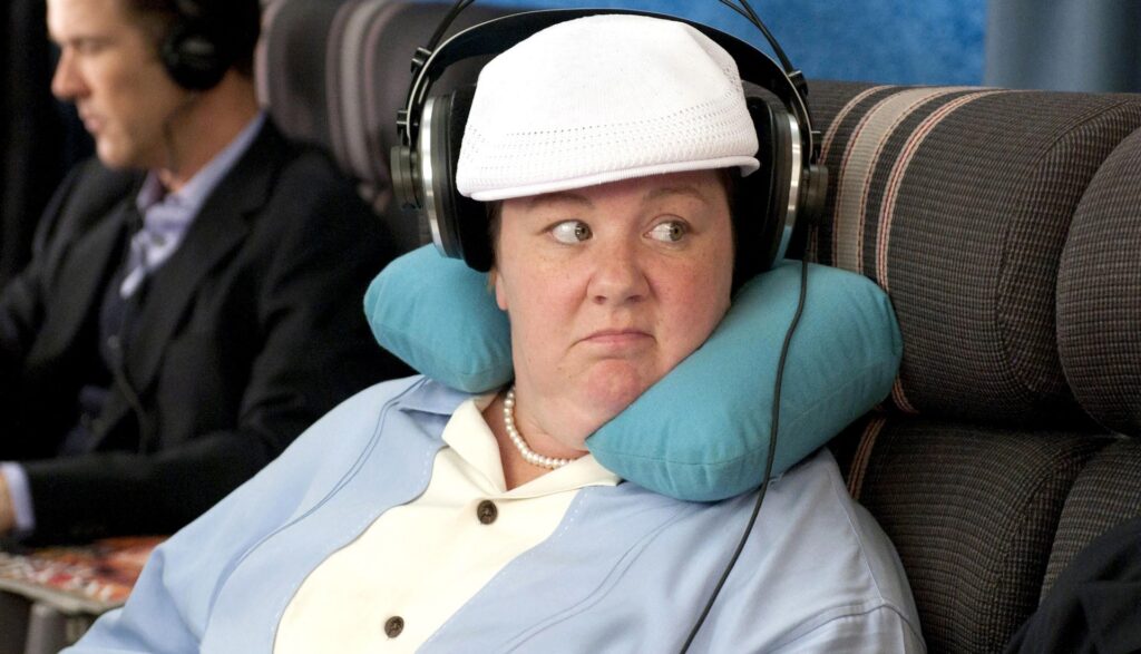 Megan (Melissa McCarthy) looking at a man on an airplane in 'Bridesmaids' (2011)