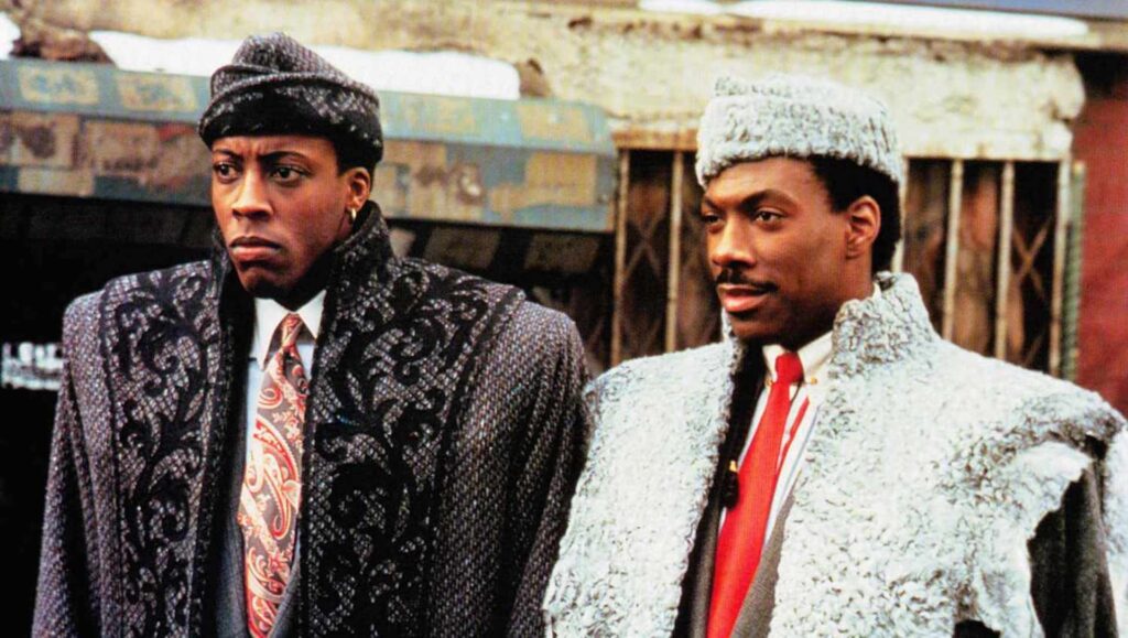 Semmi (Arsenio Hall) and Prince Akeem Joffer (Eddie Murphy) standing in the streets of New York City in 'Coming to America'