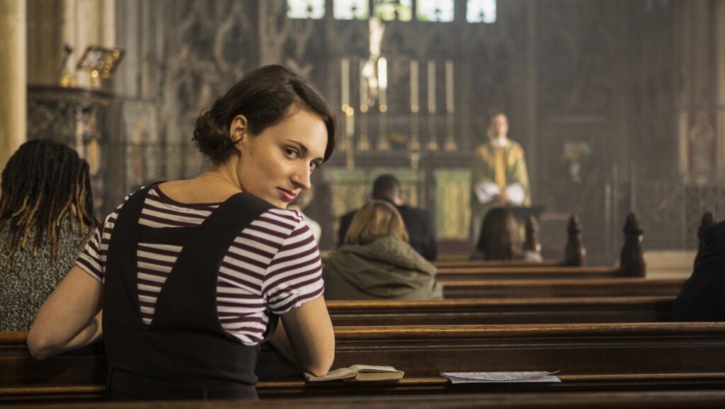 Fleabag (Phoebe Waller-Bridge) looking back at camera from a church pew in 'Fleabag,' 5 Trademarks of a Phoebe Waller-Bridge Script