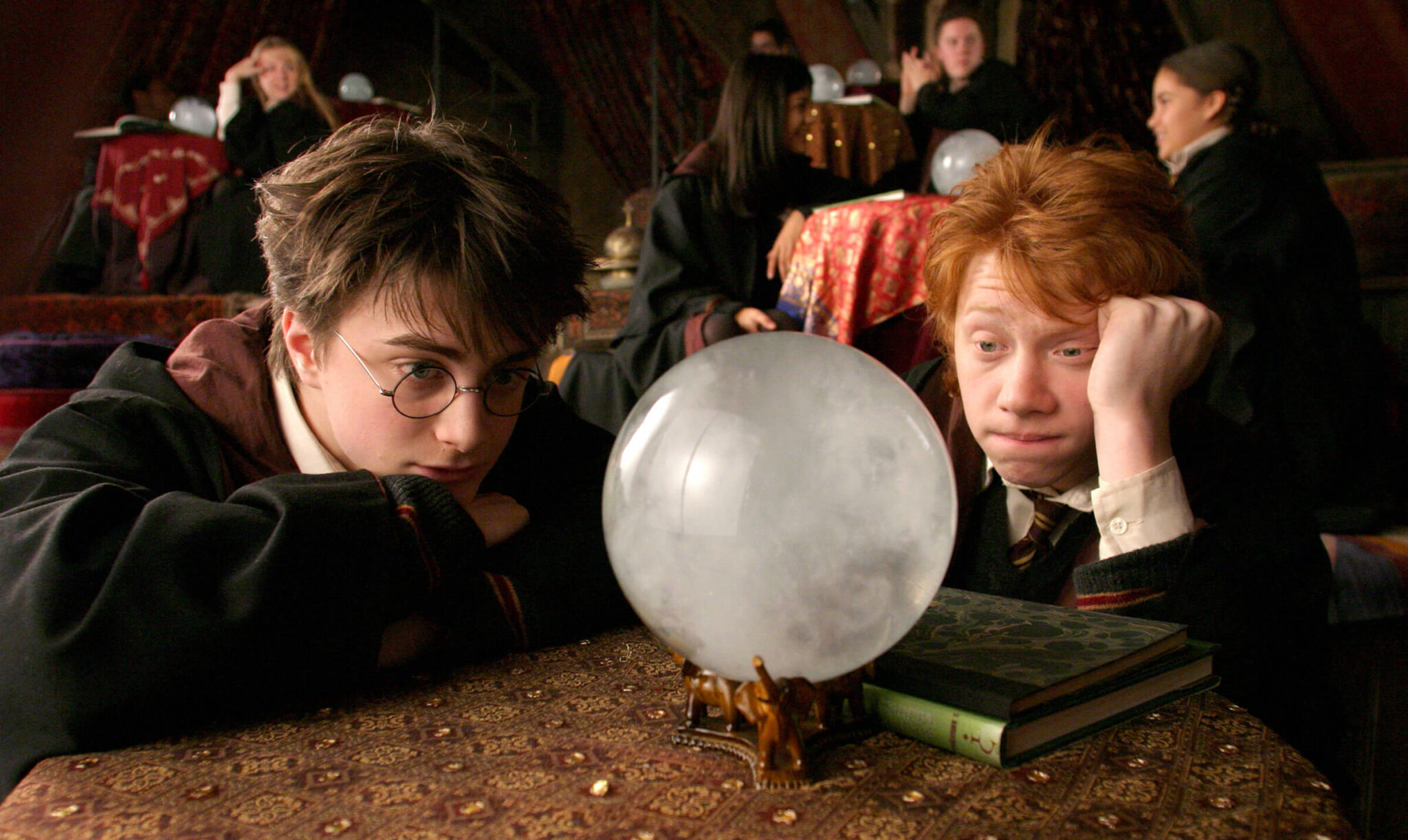 Harry (Daniel Radcliffe) and Ron (Rupert Grint) boredly staring into a glass ball in 'Harry Potter and the Prisoner of Azkaban,' 10 Sidekick Character Archetypes in Movies and TV