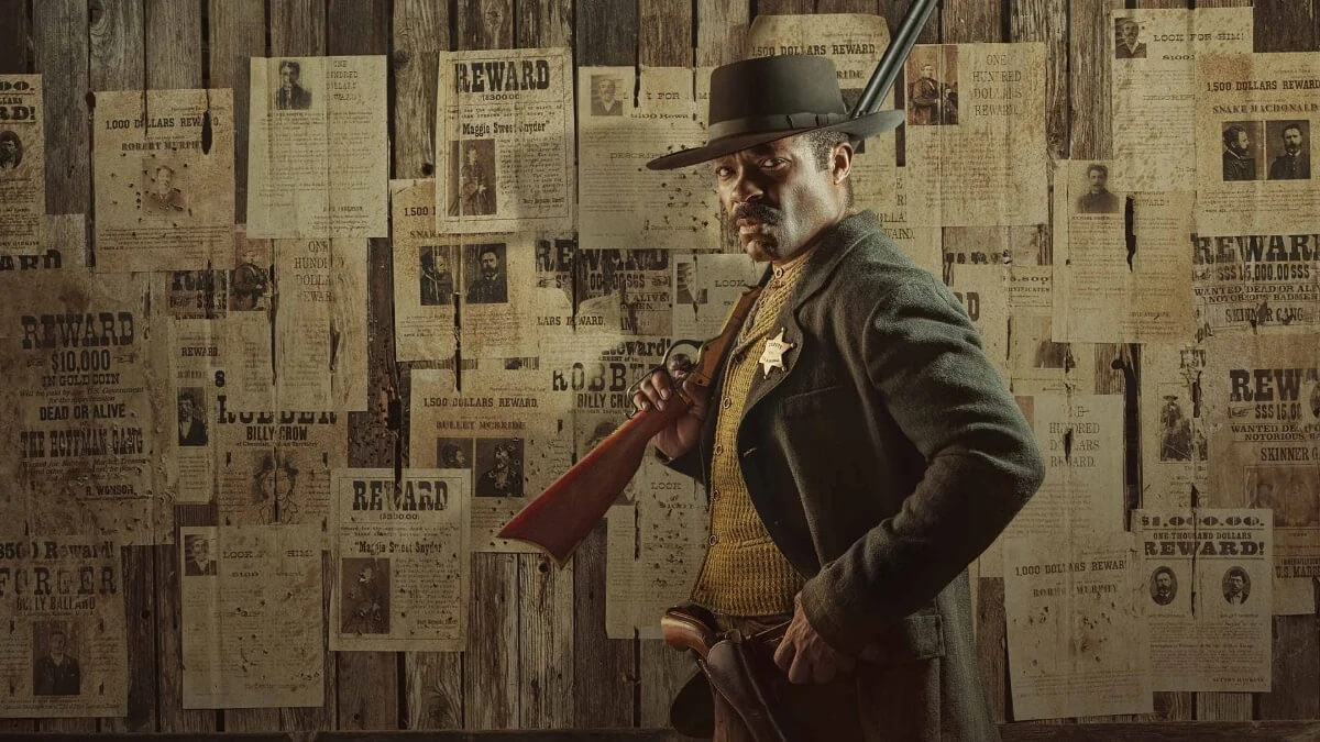 Bass Reeves (David Oyelowo) standing in front of wall with newspaper clippings in 'Lawmen: Bass Reeves' 