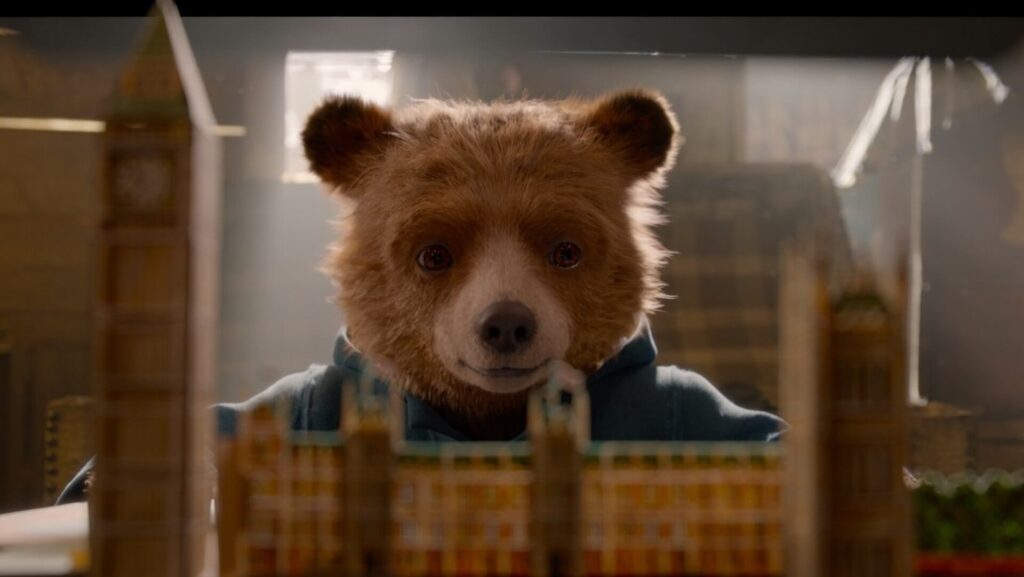 Paddington looking at a pop up picture book in 'Paddington 2'