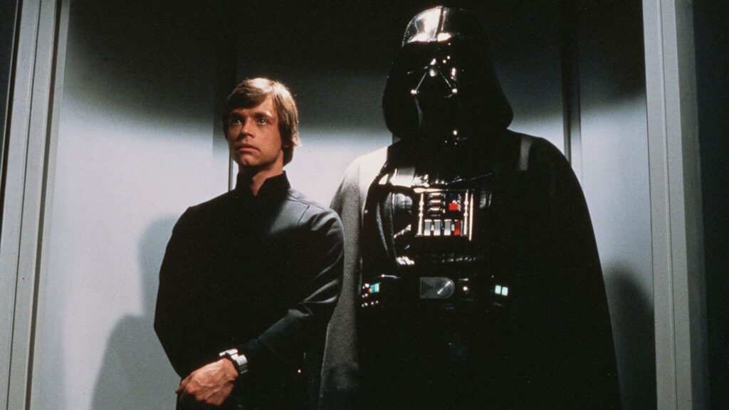 Luke Skywalker (Mark Hamill) standing next to Darth Vader (David Prowse) in an elevator in 'Star Wars: Episode VI – Return of the Jedi' 