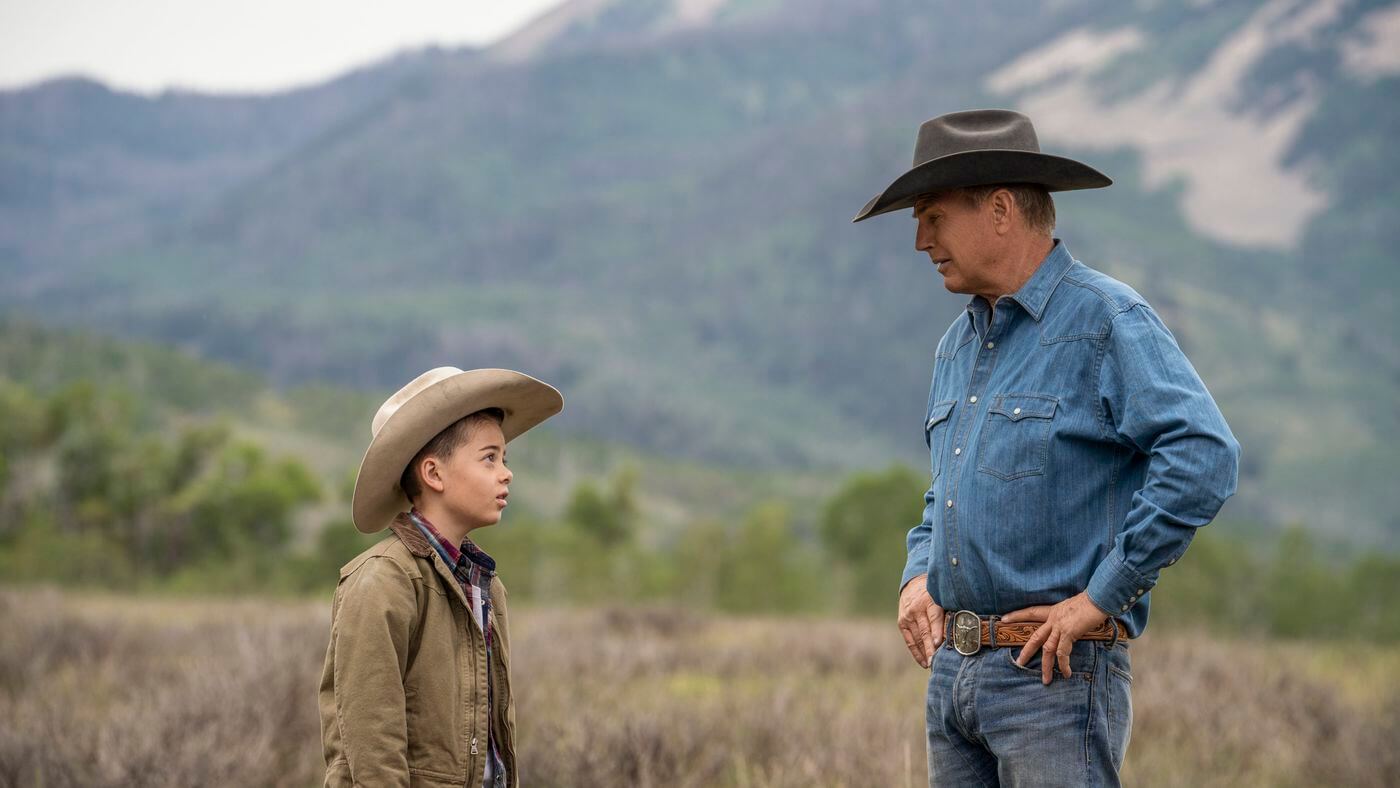 John Dutton (Kevin Costner) looking down at his grandchild in 'Yellowstone'