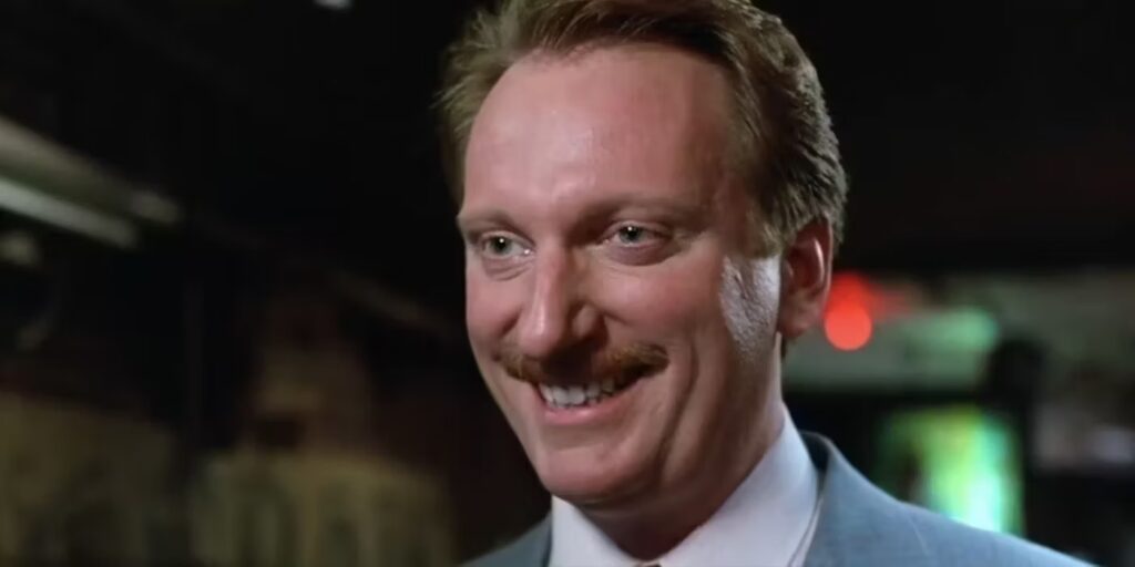 Edward "Ed" R. Rooney (Jeffrey Jones) smiling at a group in 'Ferris Bueller's Day Off,' Breaking Down the Character Archetypes of the Hero’s Journey