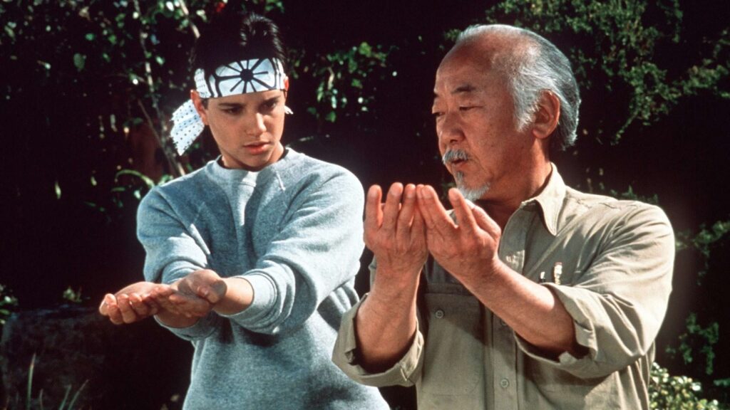 Daniel LaRusso (Ralph Macchio) watching Mr. Miyagi (Pat Morita) in 'The Karate Kid'