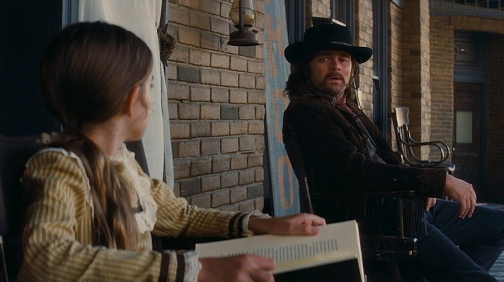 A little girl talking to Rick Dalton (Leonardo DiCaprio) in 'Once Upon a Time in Hollywood;' This Is Why Your Screenplay's Page Count Matters