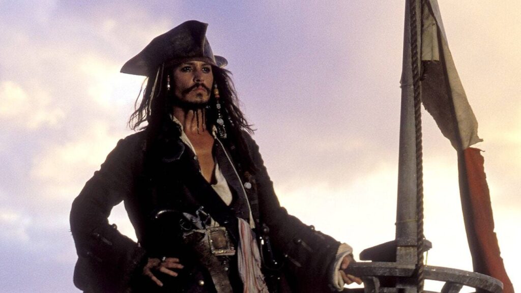 Captain Jack Sparrow standing on the top of his sinking ship in 'Pirates of the Caribbean: The Curse of the Black Pearl'