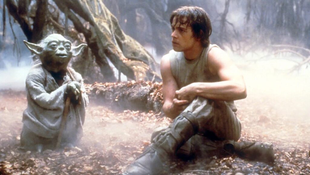 Yoda and Luke Skywalker (Mark Hamill) sitting in the forest after training in 'The Empire Strikes Back,' The Importance of Mentorship in Writing Careers