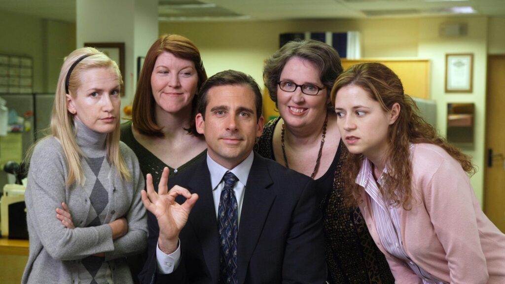 Michael Scott (Steve Carell) sitting with his female co-workers in 'The Office,' Industry Lingo Every Screenwriter Needs to Know to Succeed