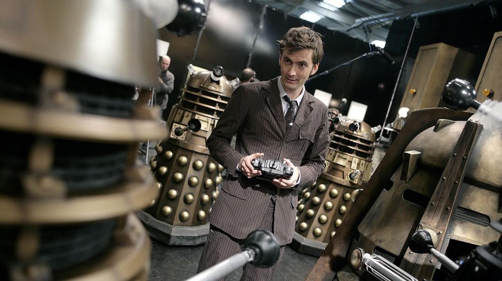 The Doctor (David Tennant) playing with several robots in 'Doctor Who'