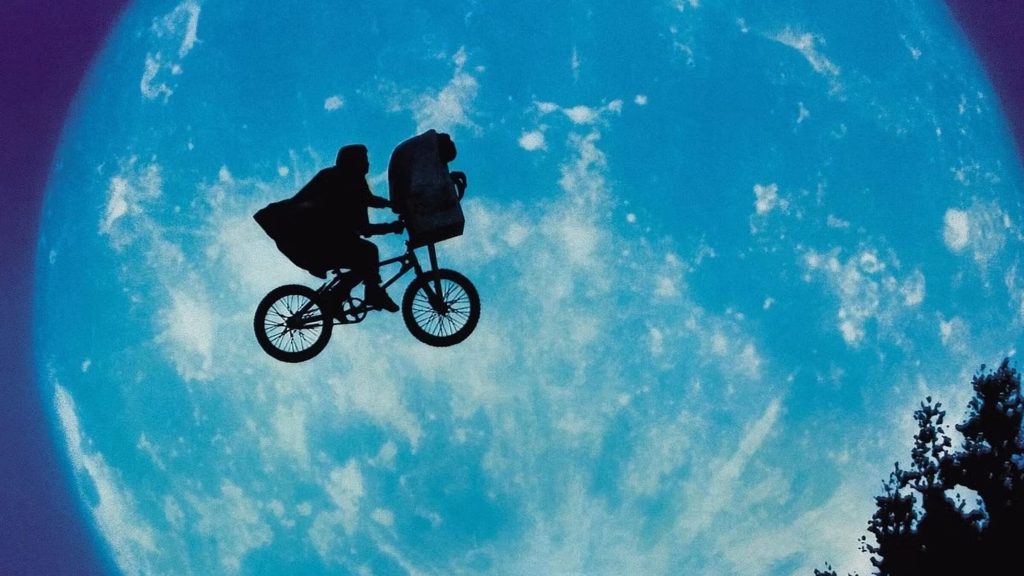 Elliot (Henry Thomas) and E.T. flying over the moon on a bicycle in 'E.T. the Extra-Terrestrial'