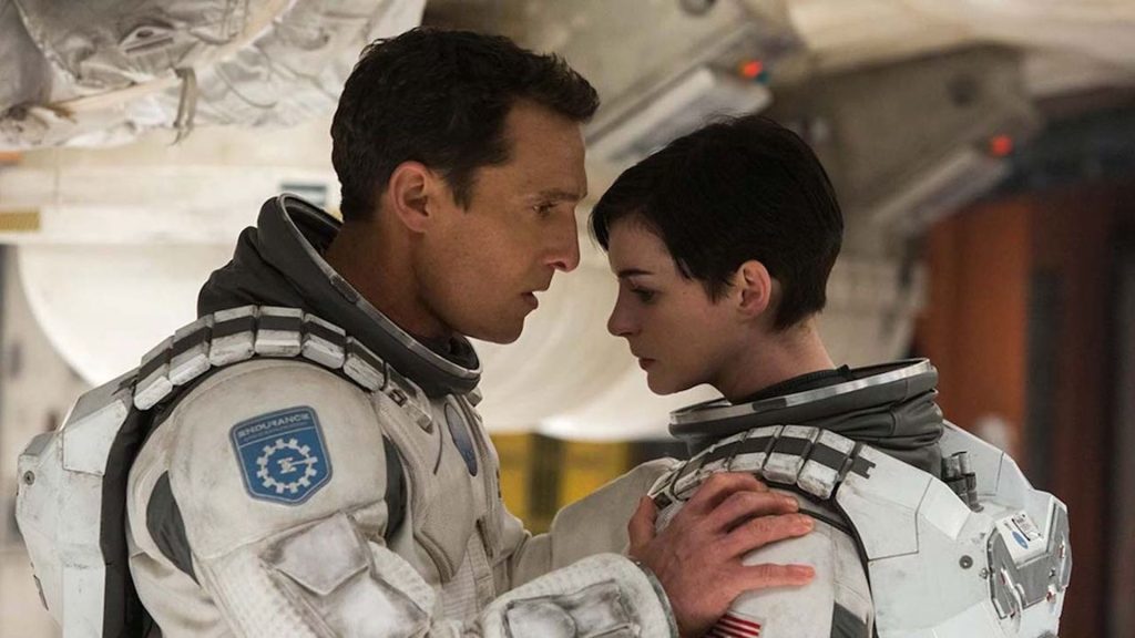 Joseph Cooper (Matthew McConaughey) talking to Amelia Brand (Anne Hathaway) in spacesuits in 'Interstellar'