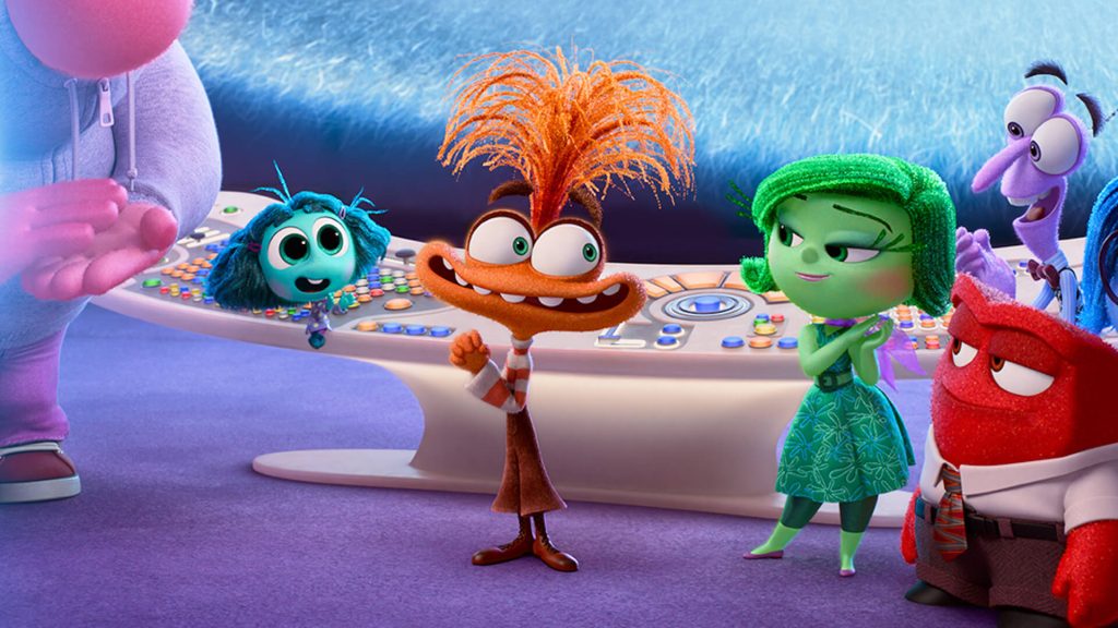 Anxiety (Maya Hawke), Envy (Ayo Edebiri), and Disgust (Liza Lapira) standing by the control board in 'Inside Out 2'