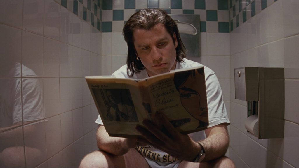 Vincent Vega (John Travolta) reading while in the bathroom in 'Pulp Fiction'