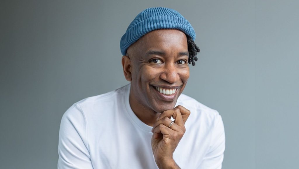 A headshot of Amadou Diallo against a grey background; How Amadou Diallo Started to See More Progression in Screenwriting Competitions