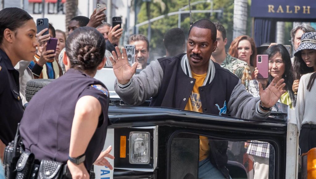 Axel (Eddie Murphy) being arrested in a large crowd of people filming on their phones in 'Beverly Hills Cop: Axel F' (2024)