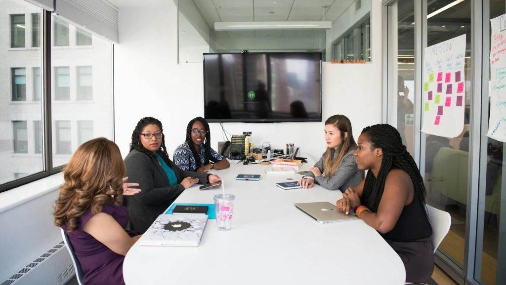 Group of Women gathered inside Conference Room, What You Need to Bring to a Pitch Meeting