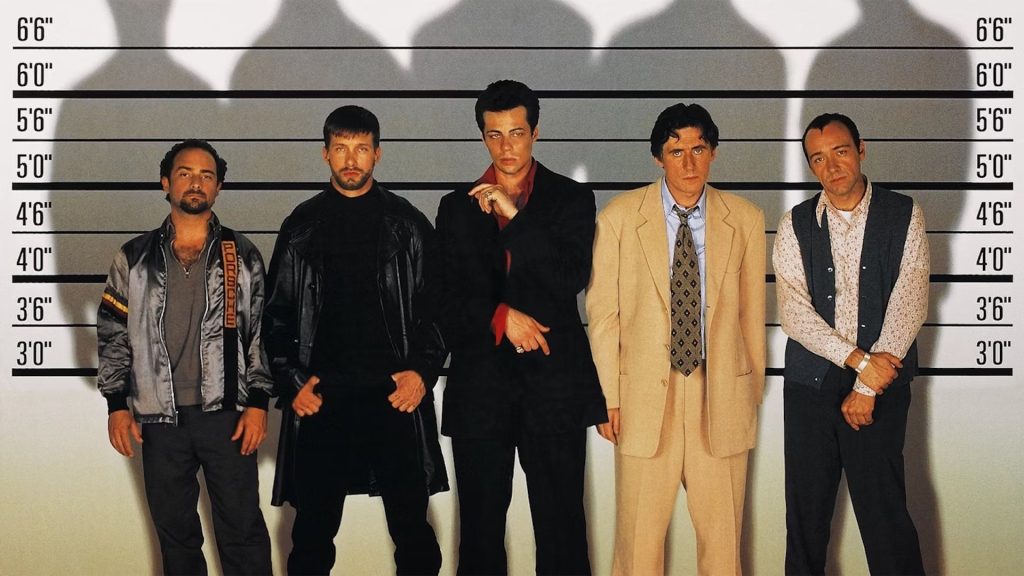 The cast of 'The Usual Suspects' standing against a wall