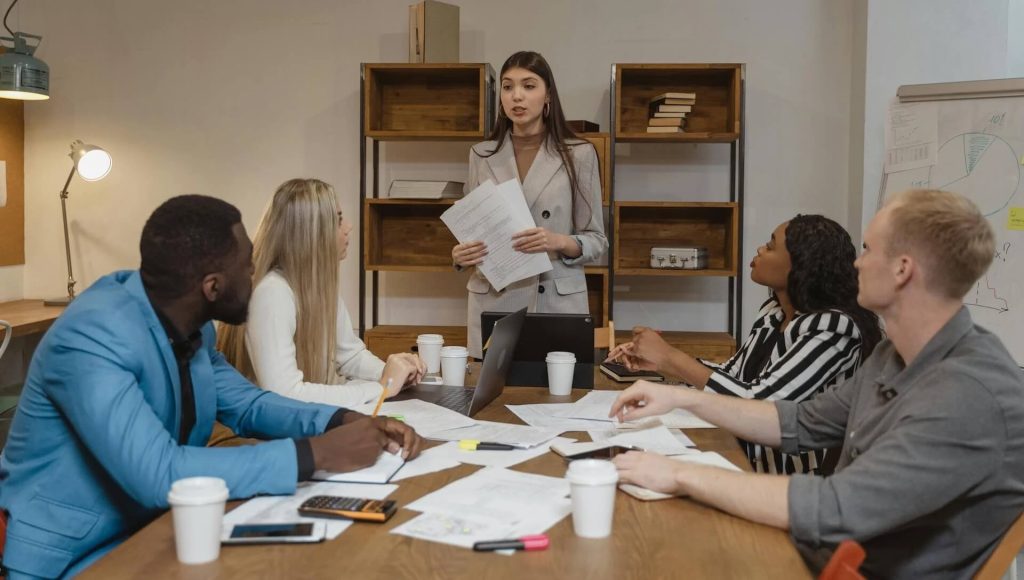 Woman in Gray Blazer Doing a Report, What You Need to Bring to a Pitch Meeting