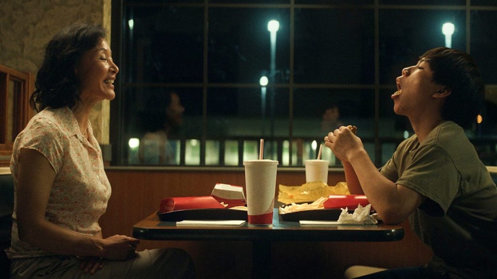 Chris Wang (Izaac Wang) and Vivian Wang (Shirley Chen) eating at a diner in 'Didi'