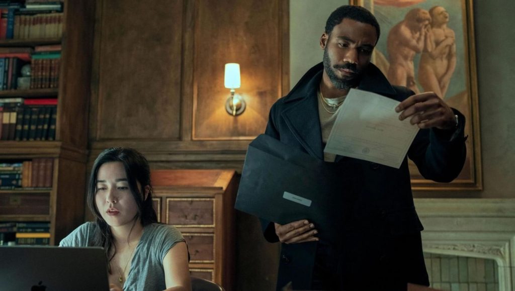 Michael (Donald Glover) and Alana (Maya Erskine) looking through files in 'Mr. & Mrs. Smith'