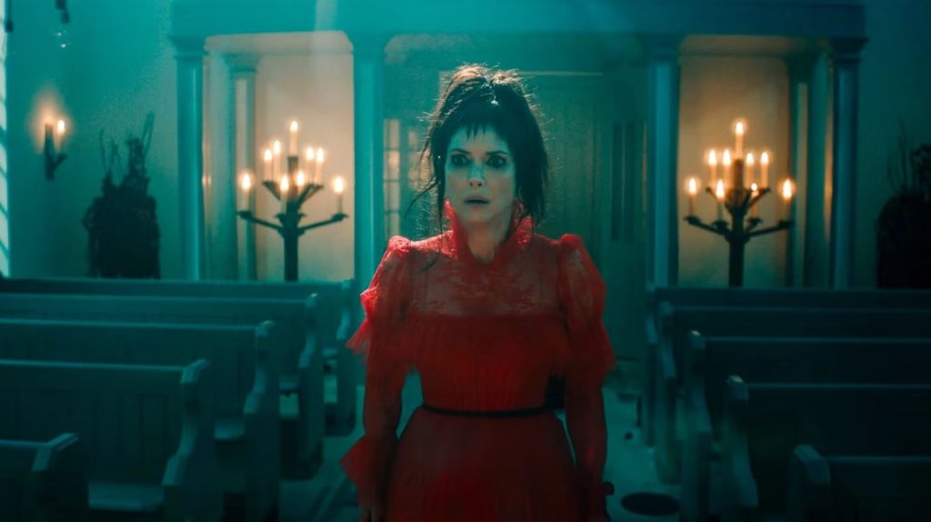 Lydia (Winona Ryder) in a red wedding dress in 'Beetlejuice Beetlejuice,' ‘Beetlejuice Beetlejuice’ Perfects Needle Drops (And You Can Master Them, Too!)