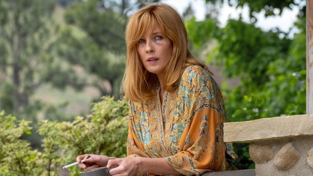 Beth Dutton (Kelly Reilly) smoking a cigarette on a porch; Unlikely Heroes: The Redeeming Character Traits in 'Yellowstone.'