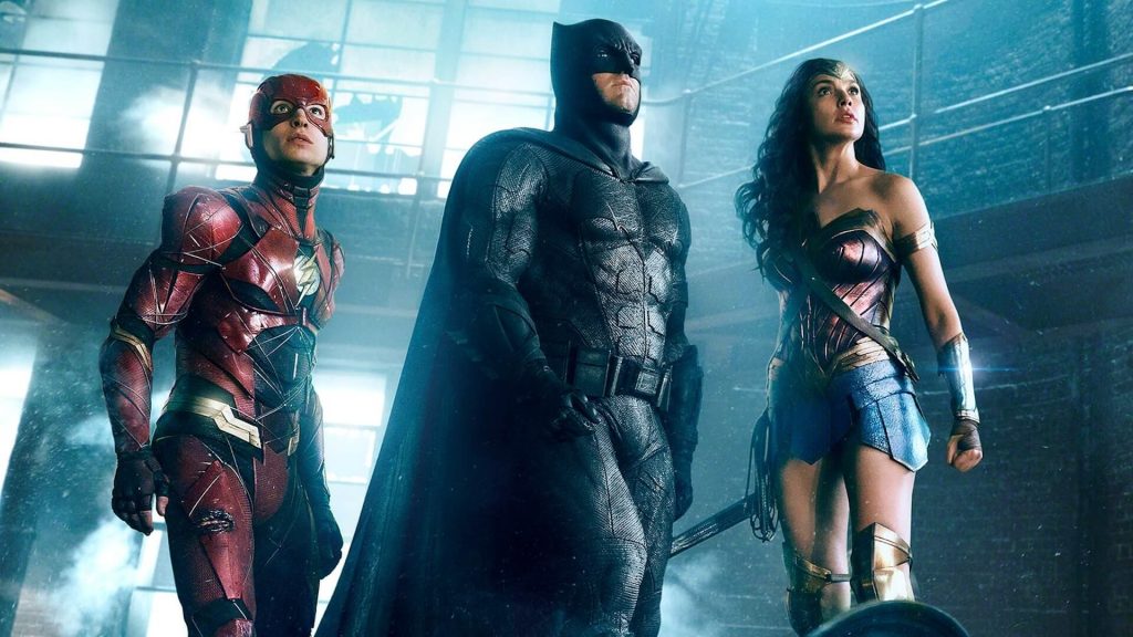 The Flash (Ezra Miller), Batman (Ben Affleck), and Wonder Woman (Gal Gadot) fighting villains in 'Justice League'